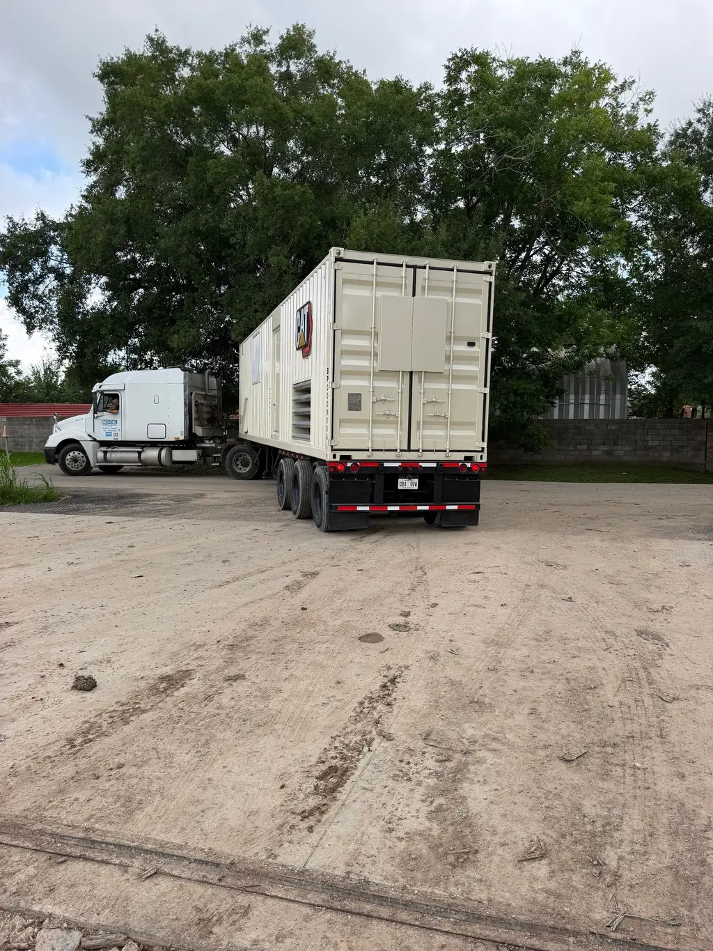 Tractor with a container-style equipment unit on a trailer