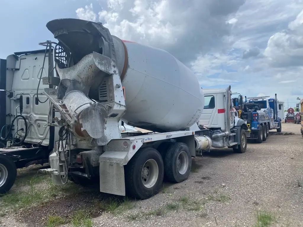 Side view of a rolled mixer truck in the storage yard